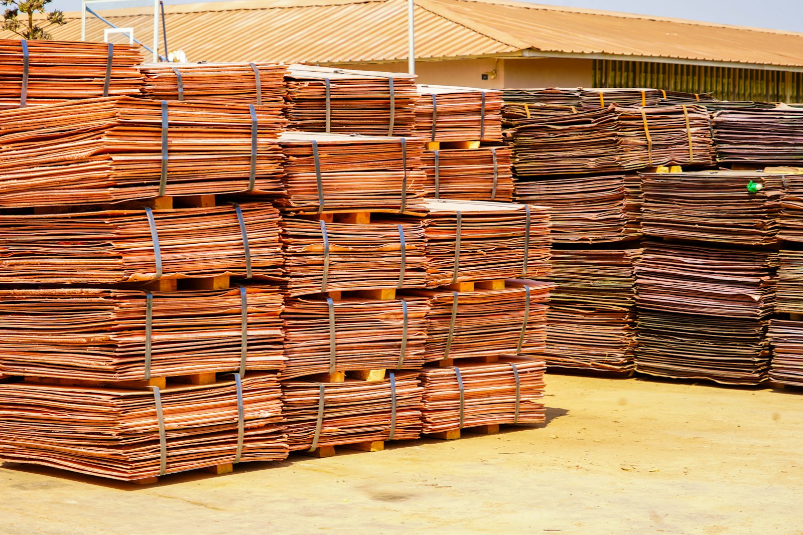 Stacked bundles of copper cathode sheets in a storage yard