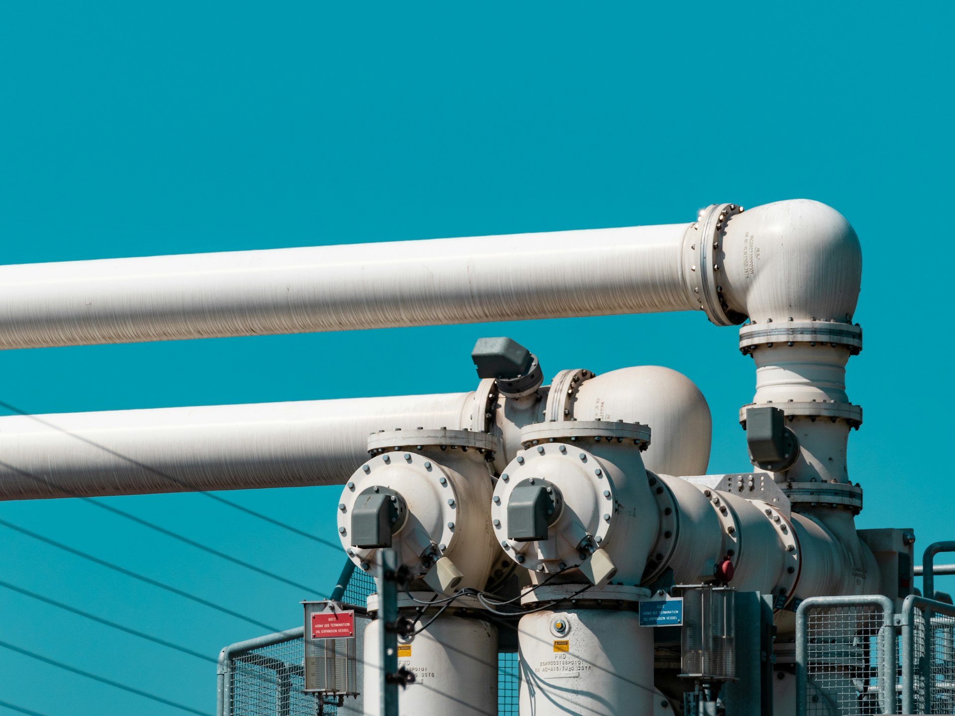 Large industrial gas pipework and valves against a clear sky
