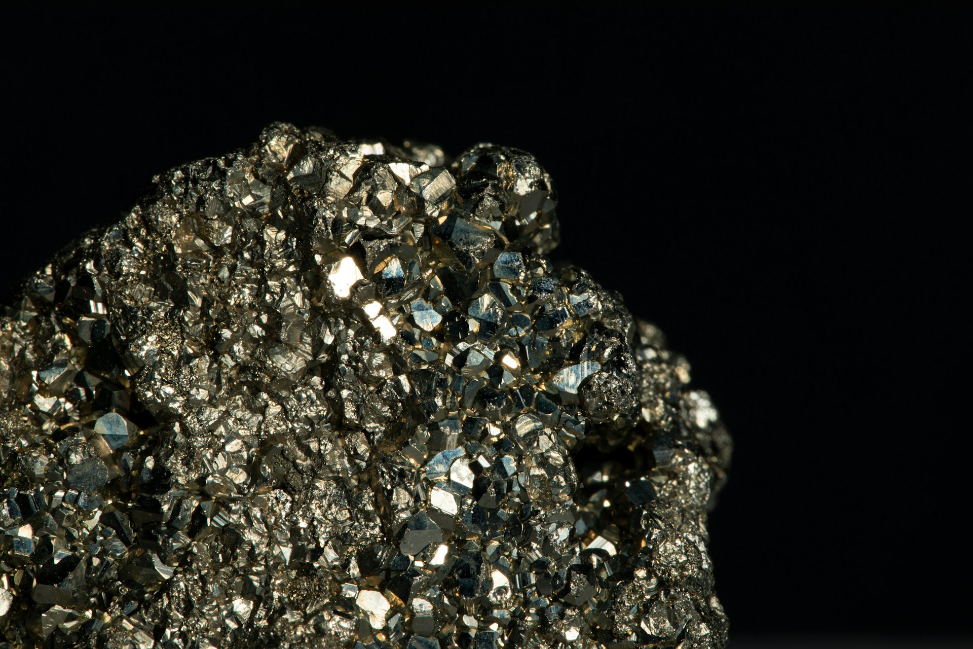 Close-up of a metallic sulphide ore specimen on a dark background