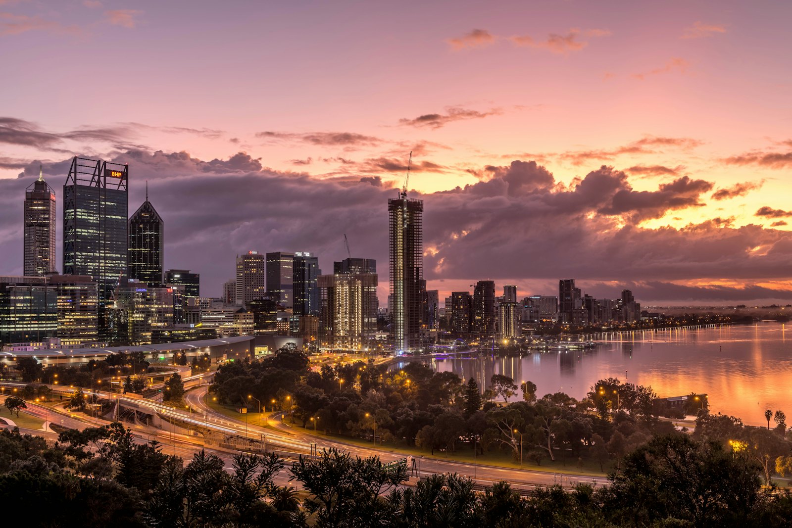 Perth city skyline beside the Swan River at sunset