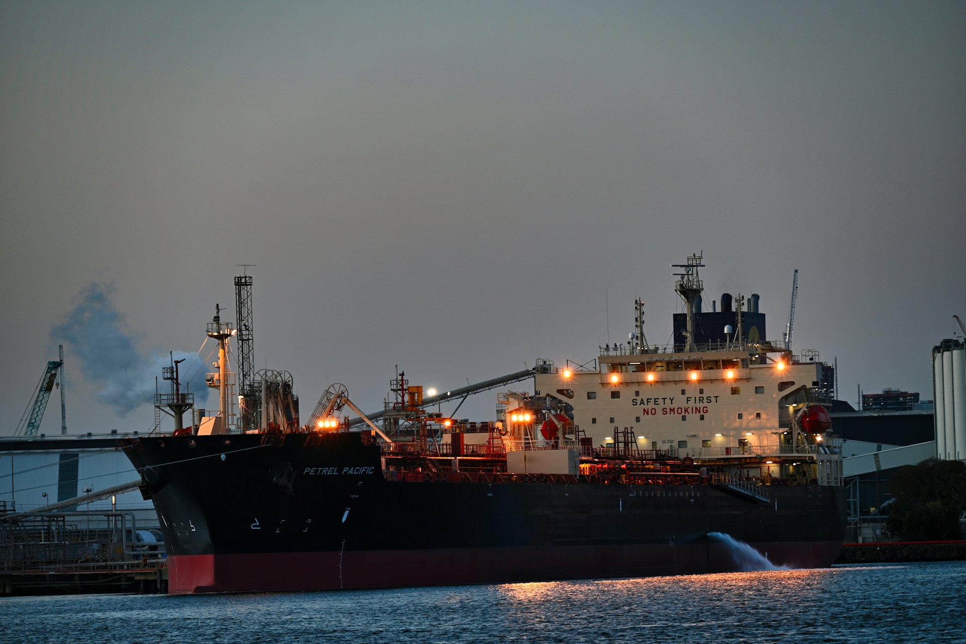 Tanker vessel lit up in a harbour at night
